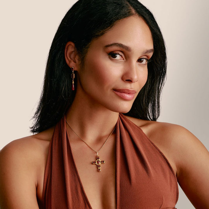 Woman wearing a rust-colored halter top with a neutral background