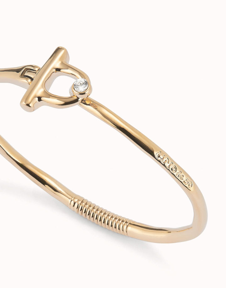 Fashionable 18k Gold Plated Ser Indomable White Bangle Bracelet PUL2449BLNORO0 displayed on a chic surface, emphasizing its modern geometric shapes and elegant style.