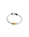 A silver beaded bracelet with a single gold teardrop-shaped accent bead and a black cord closure, shown on a plain white background.