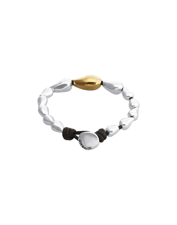 A silver beaded stretch bracelet with a polished gold teardrop-shaped bead, a black cord, and a round silver disc charm engraved with 'SUNRISE'.