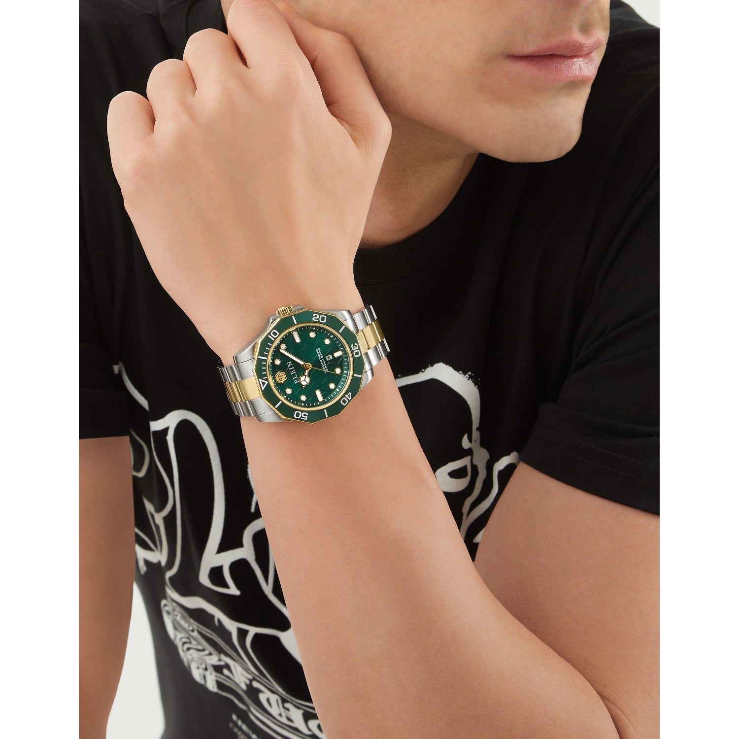 Person wearing a green watch with a black shirt