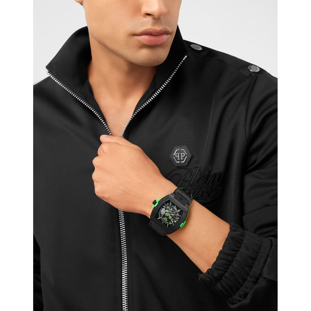 Man wearing a black jacket with a brand logo and a black watch on his wrist.