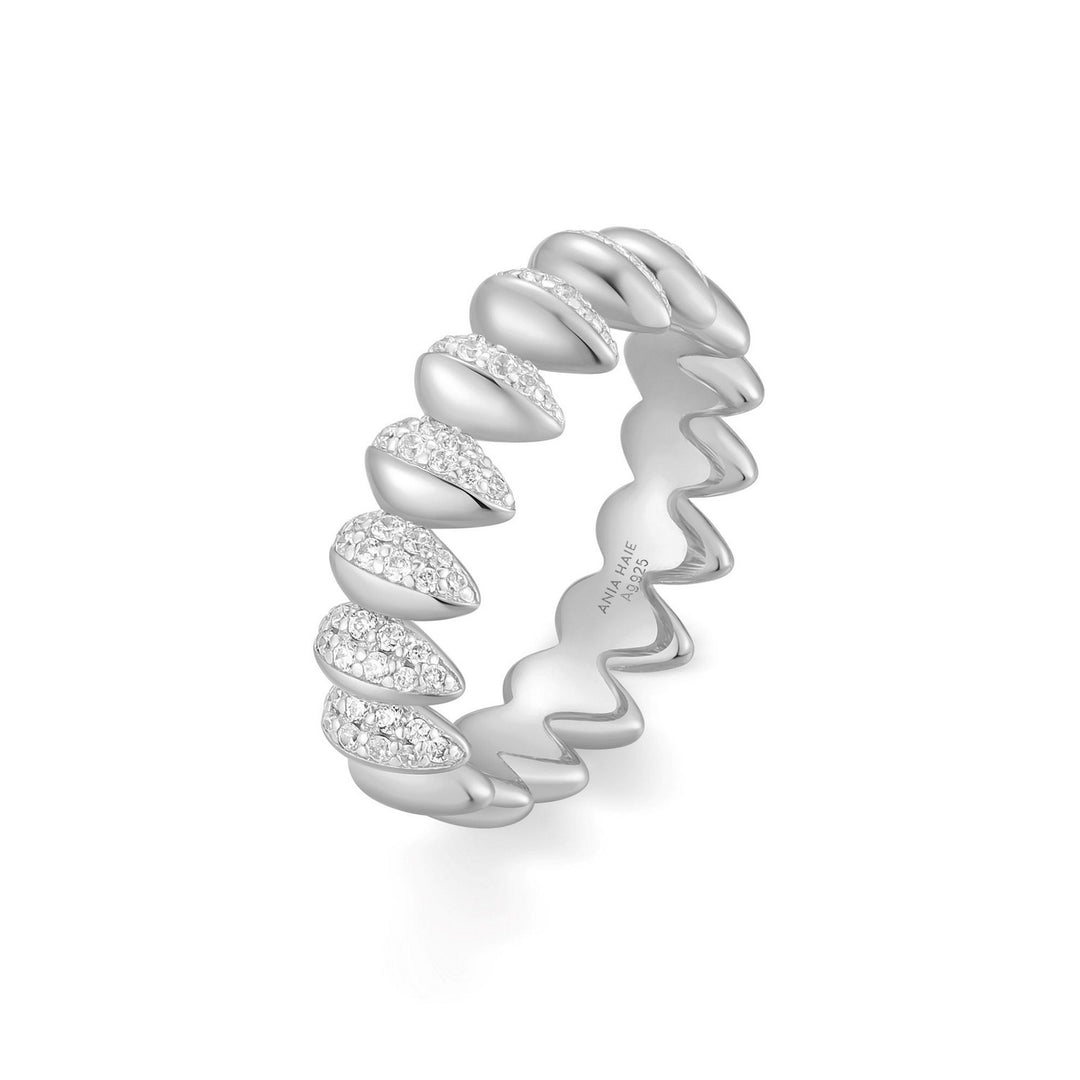Silver ring with a wavy design and small diamonds on a white background