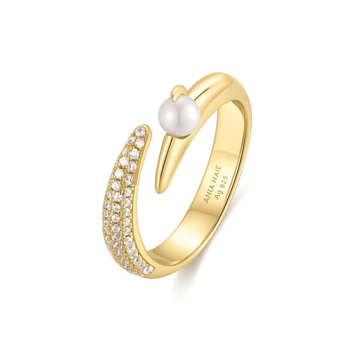 Gold ring with a pearl and small diamonds on a white background