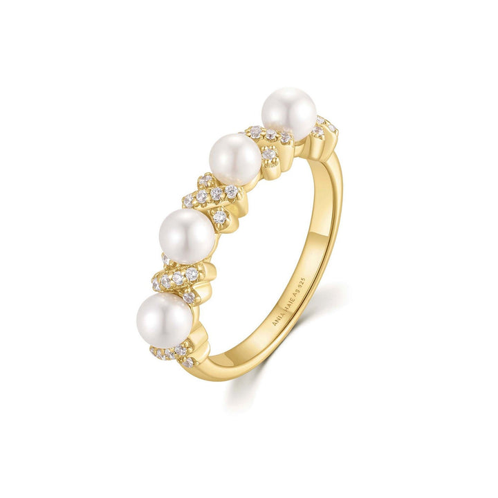 Gold ring with pearls and diamonds on a white background
