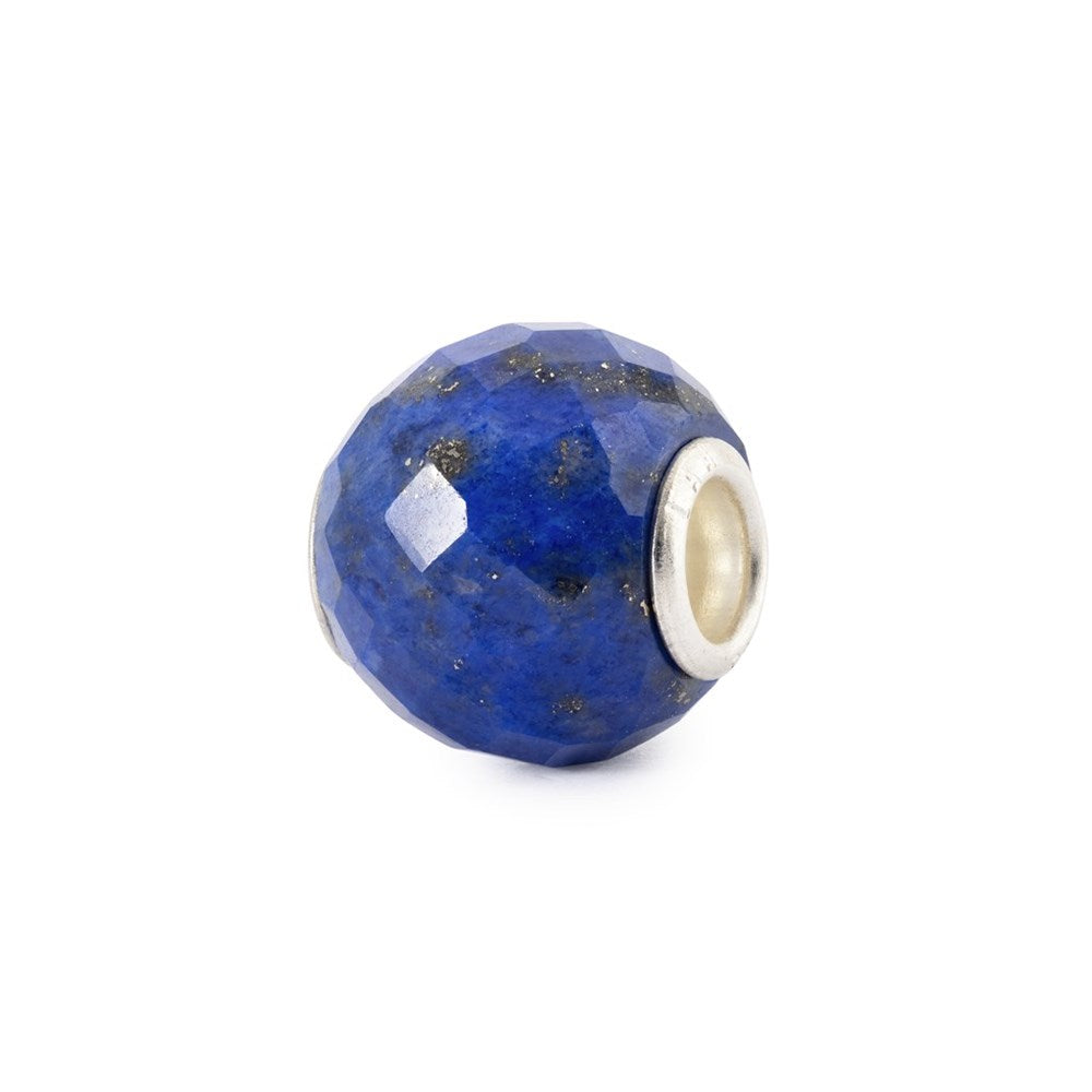 Blue faceted bead with silver core on a white background