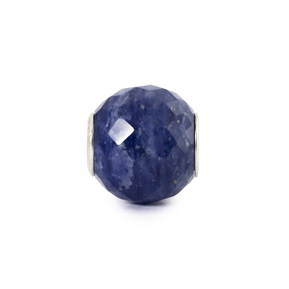 A faceted blue lapis lazuli stone bead with silver metal end caps, centered on a plain white background.