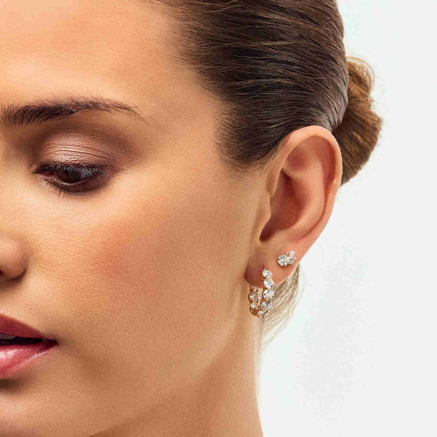 Side view of a model wearing the 14k White Gold Ariccia Diamond Earrings SJ-E2528-WD-WG, featuring a refined design and luxurious lab-grown diamonds, embodying sophistication and style.