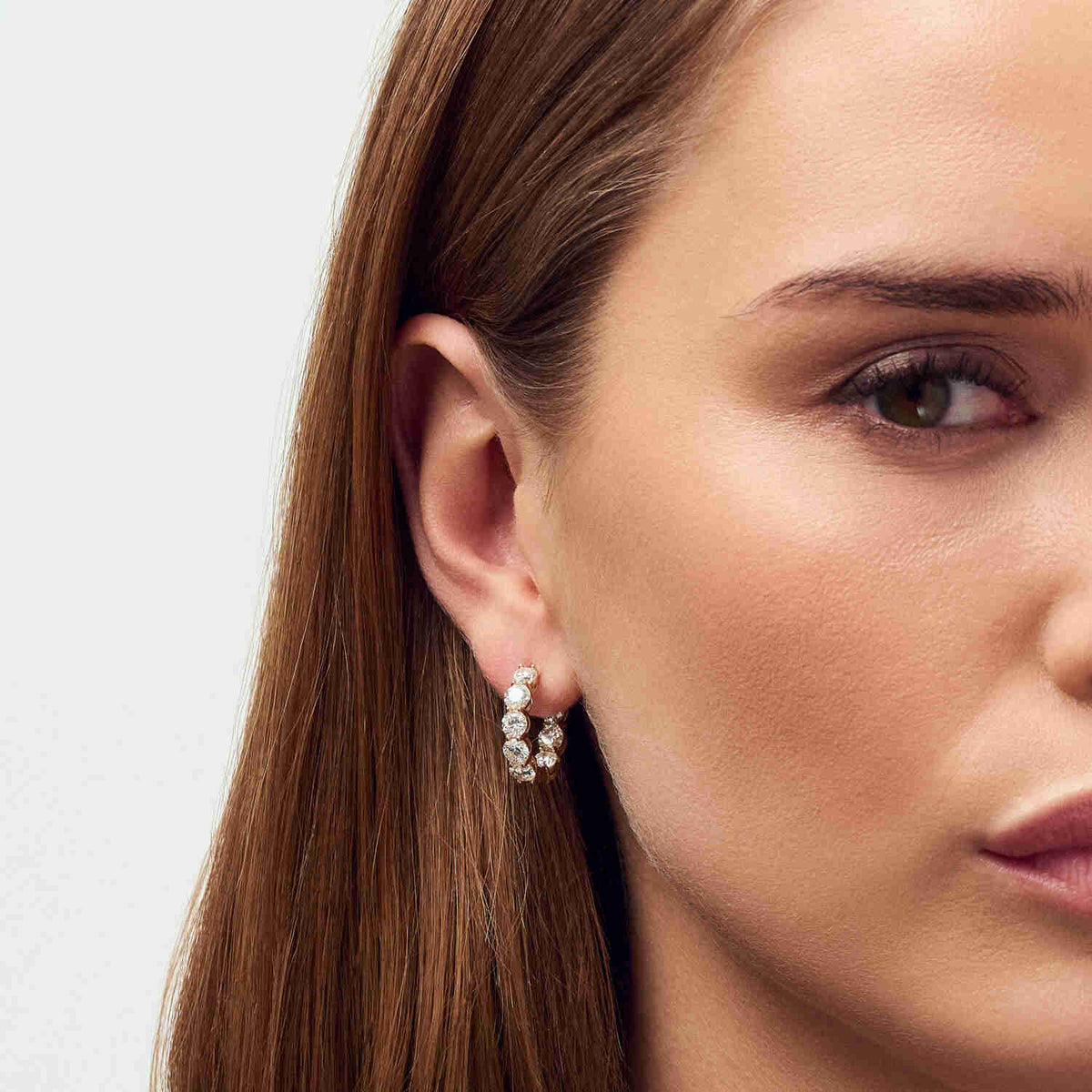 Close-up of 14k Yellow Gold Ariccia Diamond Earrings SJ-E2528-WD-YG on a model, emphasizing the exquisite detail and brilliance of the diamonds. Luxury earrings for refined taste.