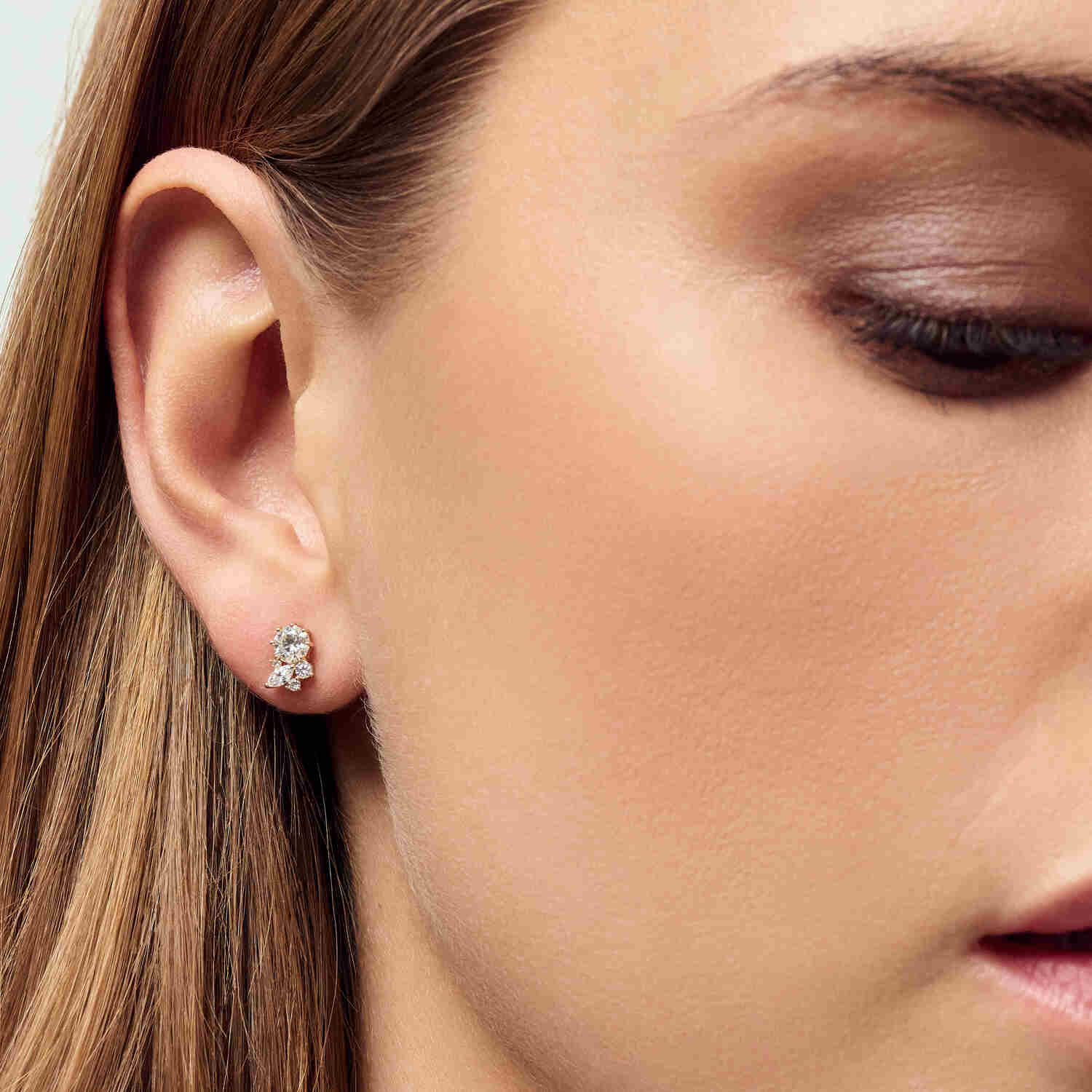 Close-up of a model wearing the 14k Yellow Gold Lovere Diamond Earrings SJ-E2550-WD-YG, highlighting the exquisite design and sparkle of the earrings.