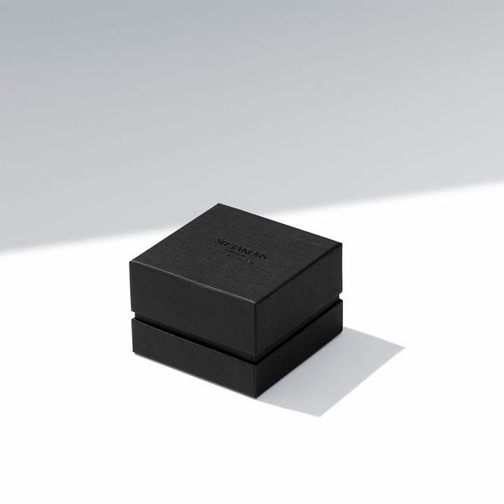 Black jewelry box with 'Swarovski' branding on a light gray background