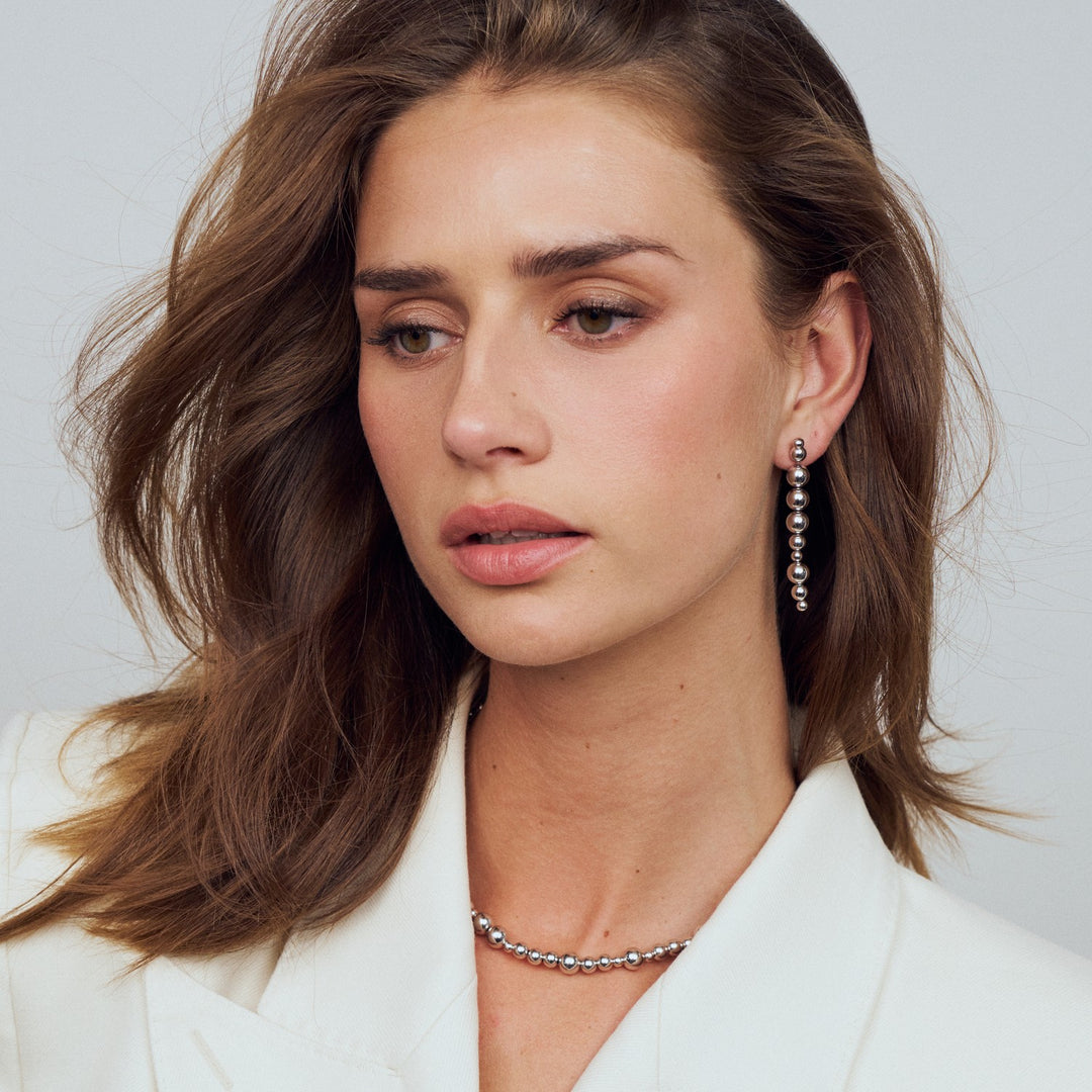 Woman wearing a white blazer with a neutral background