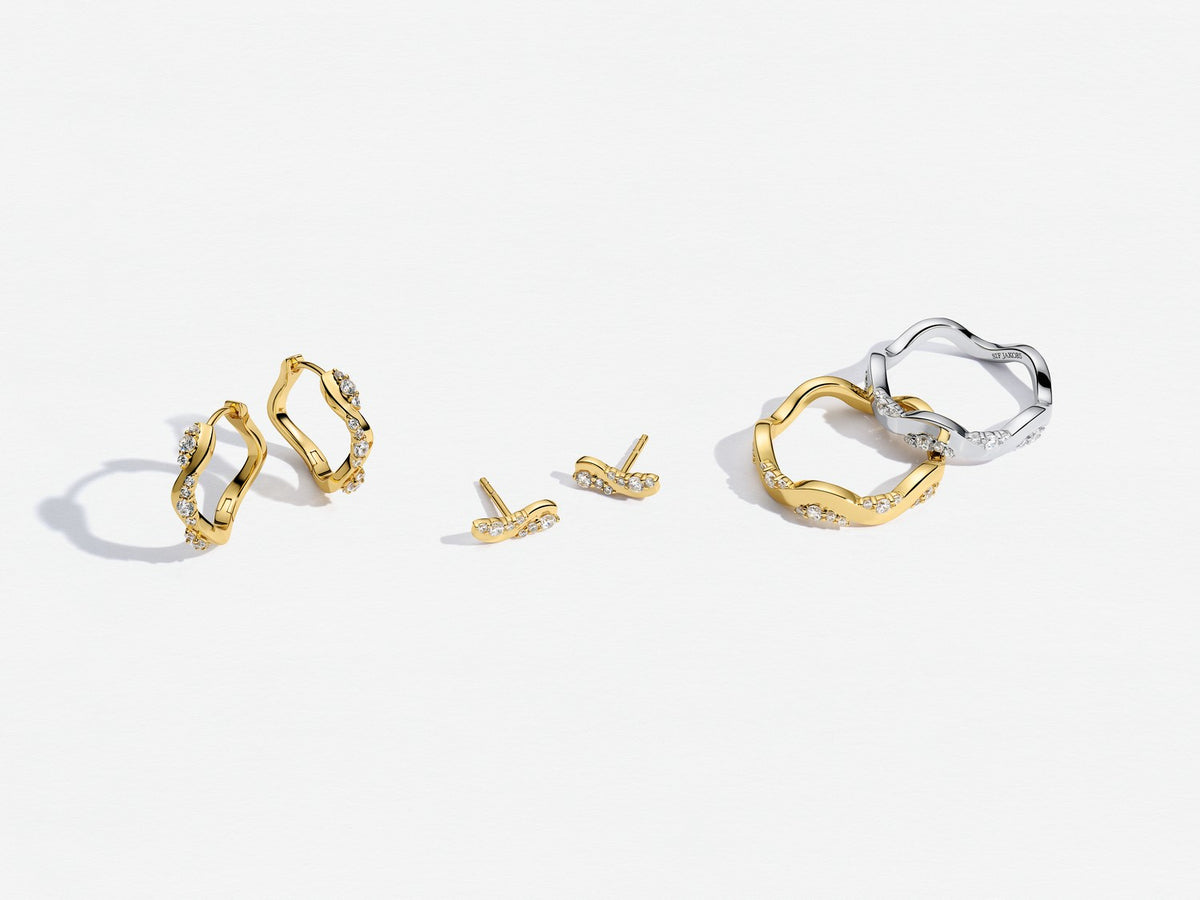 Gold and silver hoop earrings on a white background
