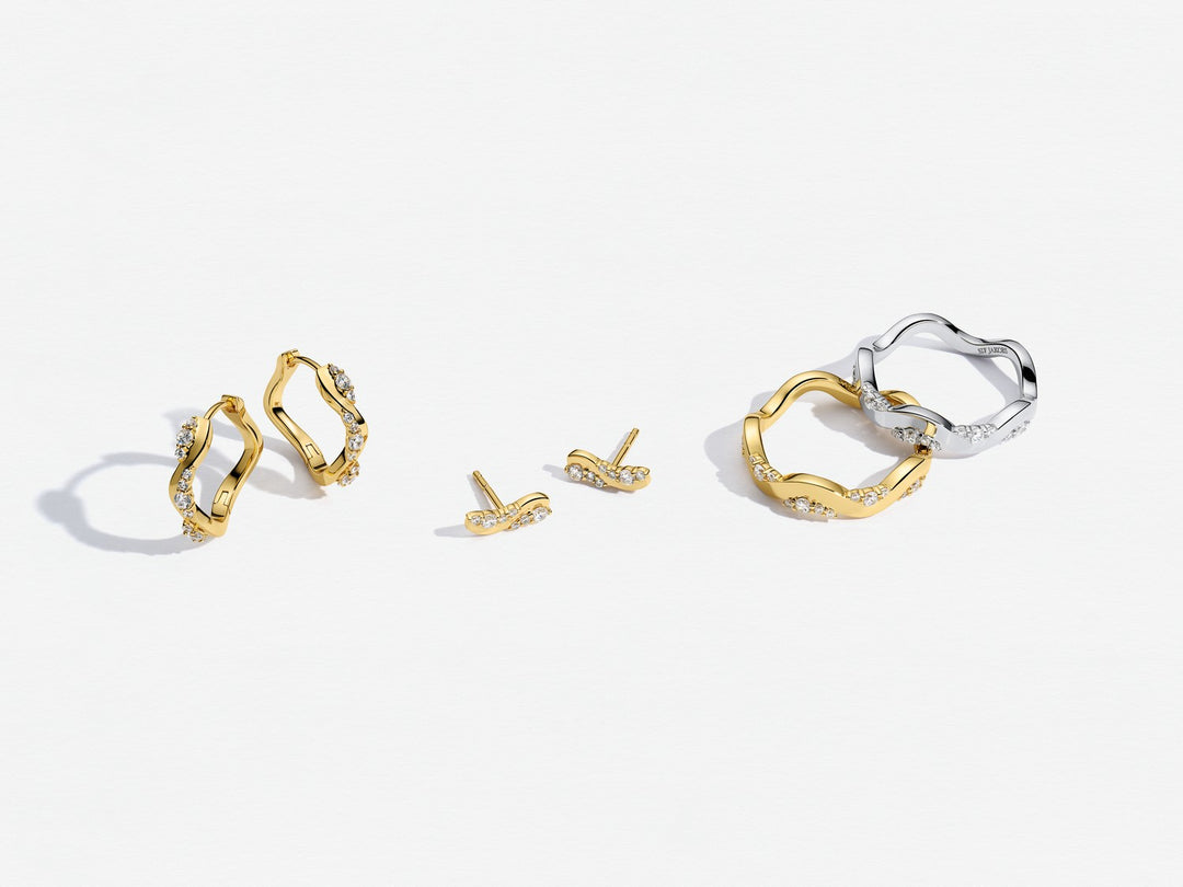 Gold and silver hoop earrings on a white background