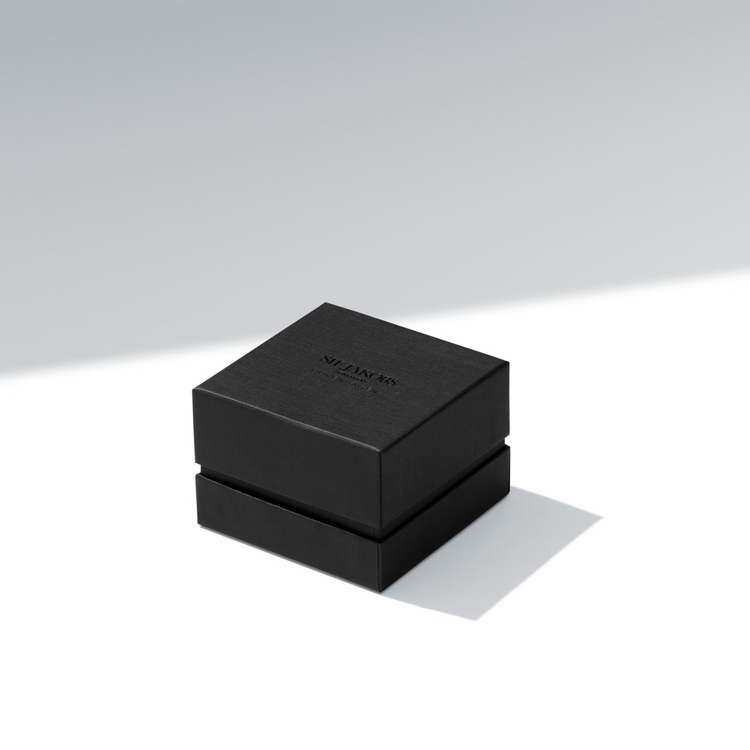 Black jewelry box with 'Swarovski' branding on a light gray background
