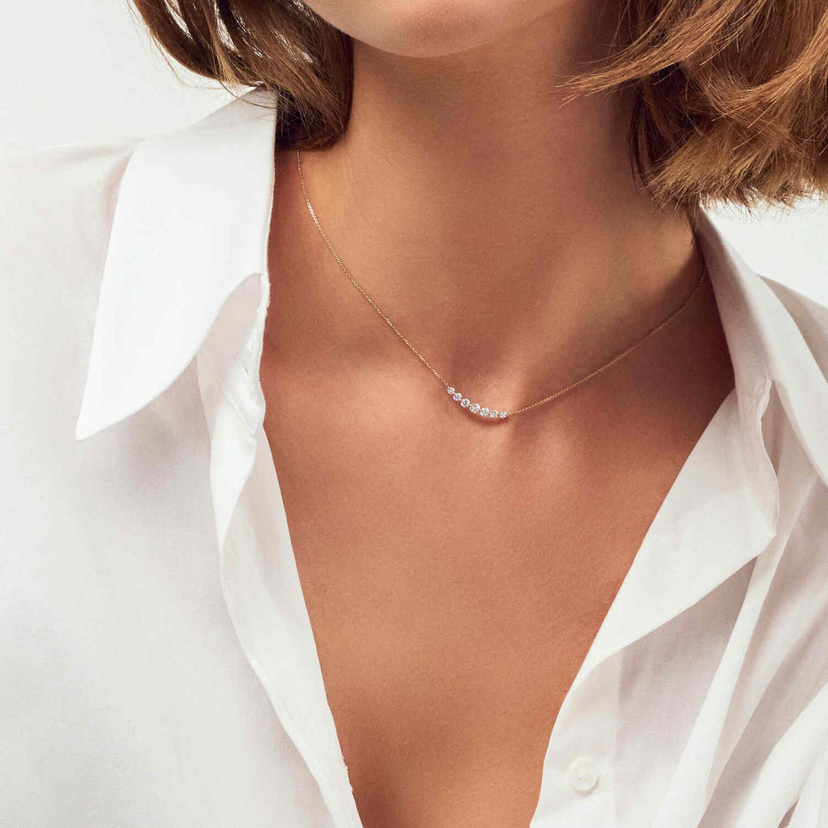 Model wears the stunning 14k White Gold Tiara Grande Diamond Necklace SJ-N2519-WD-WG, a luxurious necklace featuring exquisite lab-grown diamonds on a fine chain.