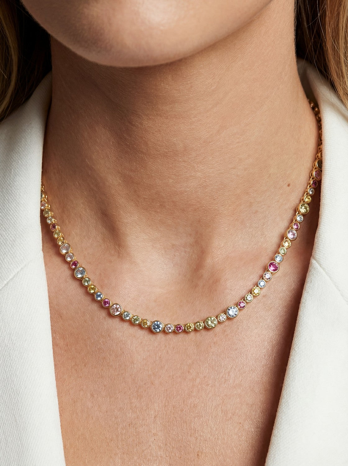 Multicolored beaded necklace on a person wearing a white blazer