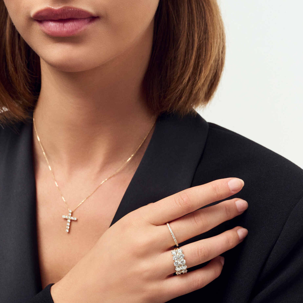 Close-up of a stylish model wearing the 14k Yellow Gold Ariccia Diamond Ring SJ-R2531-WD-YG, highlighting its exclusive shine and luxurious appeal paired with a delicate gold necklace.