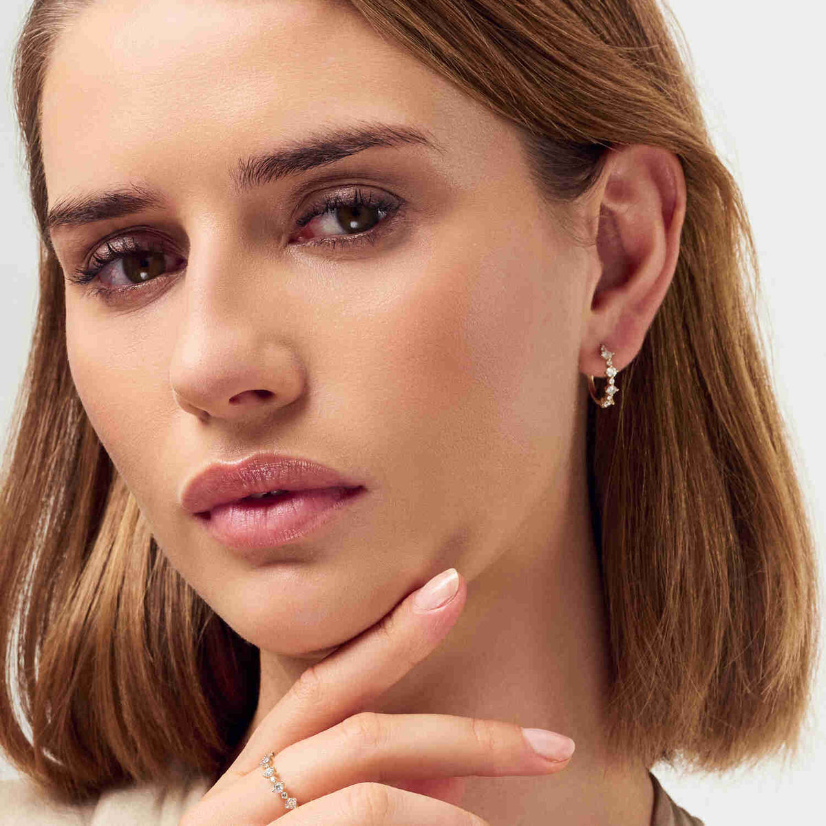 Close-up of a sophisticated model wearing the 14k White Gold Brina Diamond Ring SJ-R2535-WD-WG, highlighting the ring's luxurious diamonds and exquisite craftsmanship.