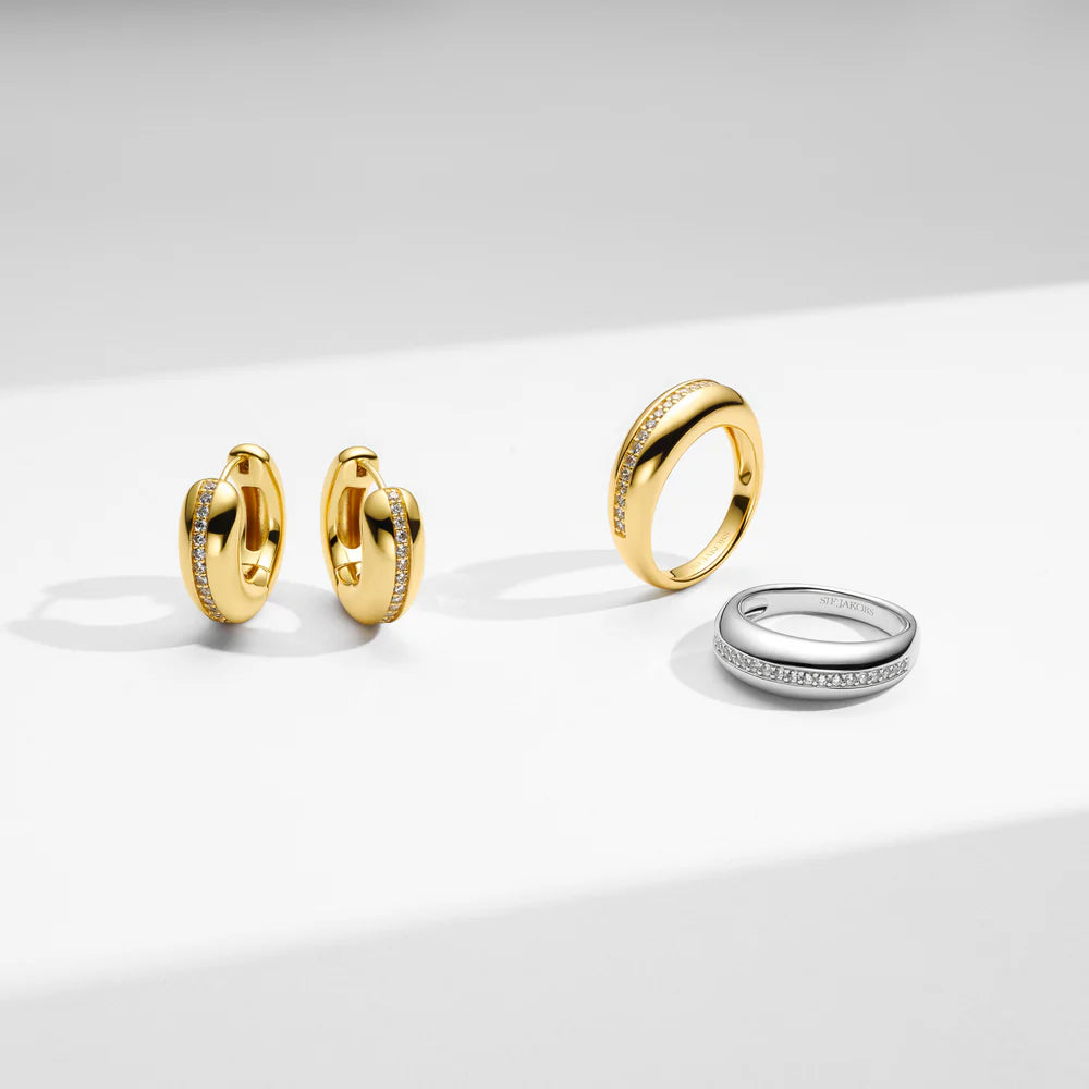 Set of gold and silver rings on a light gray background