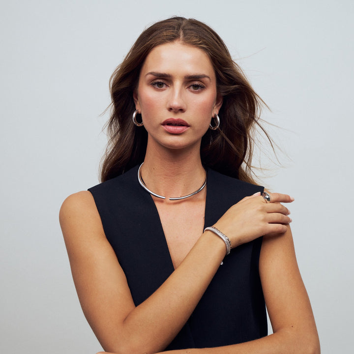 Woman wearing jewelry against a plain background
