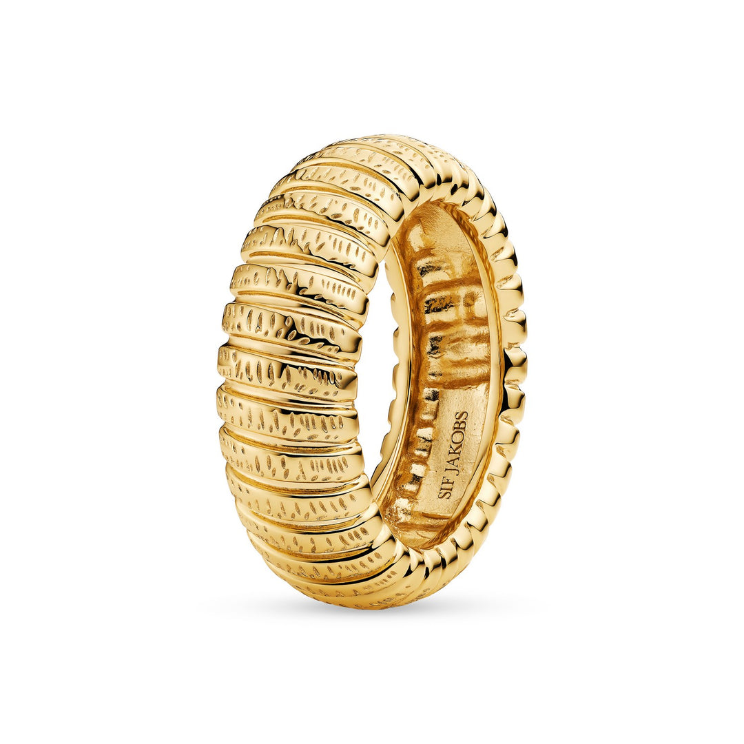 Gold ring with textured design on a white background