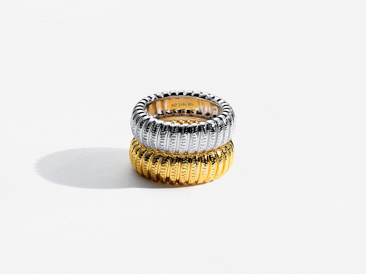 Three stacked rings with a brand name on a white background