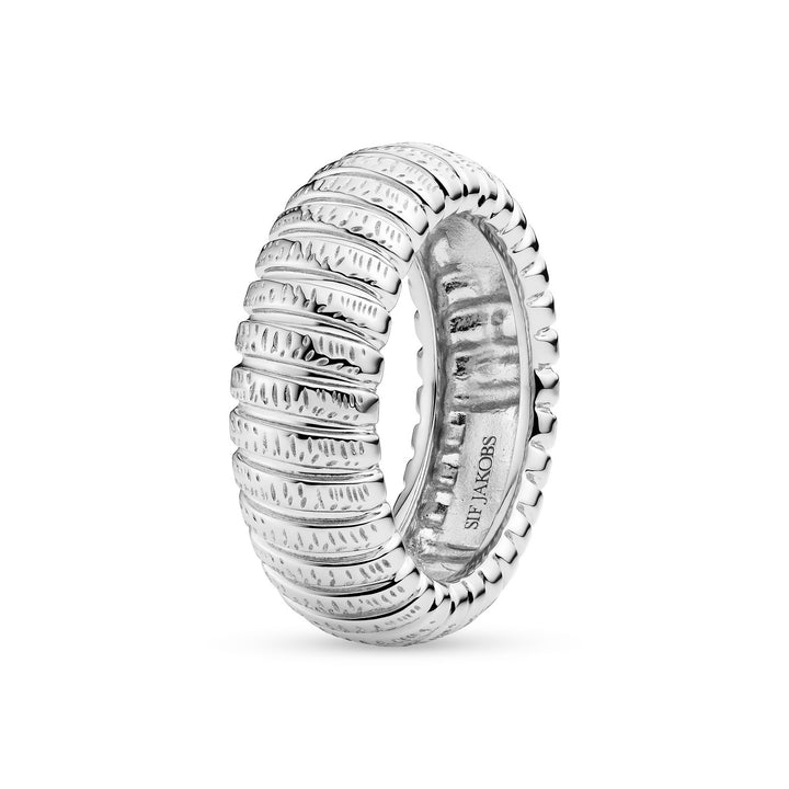 Silver ring with textured design on a white background