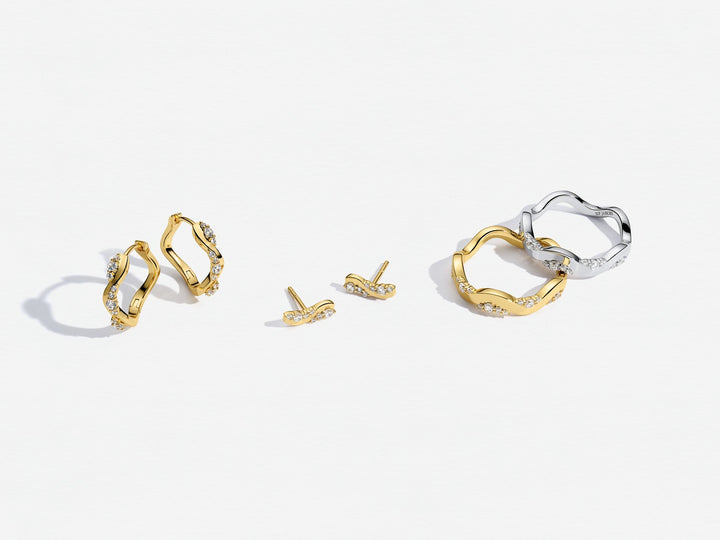 Gold and silver hoop earrings on a white background