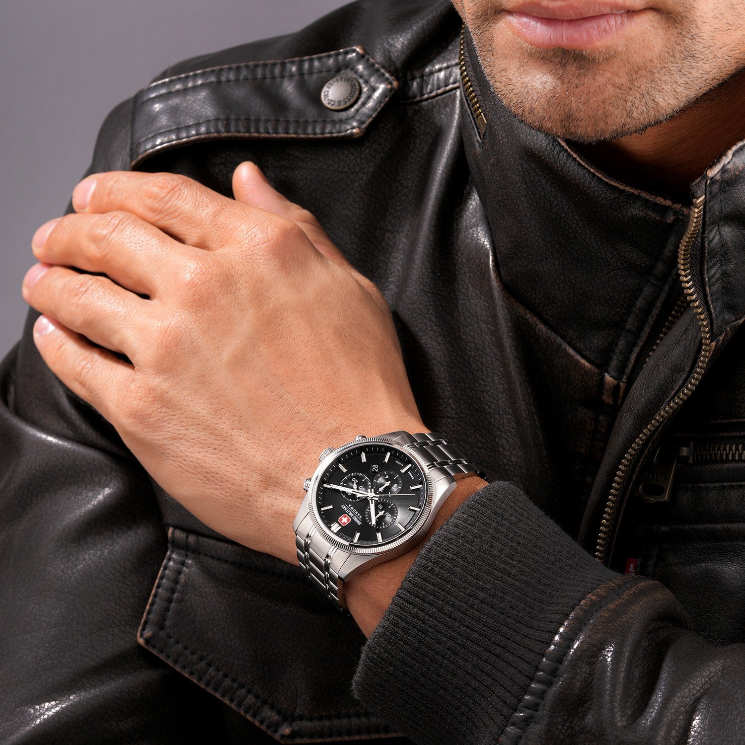 Swiss Military watch with black dial and silver metal strap on a white background