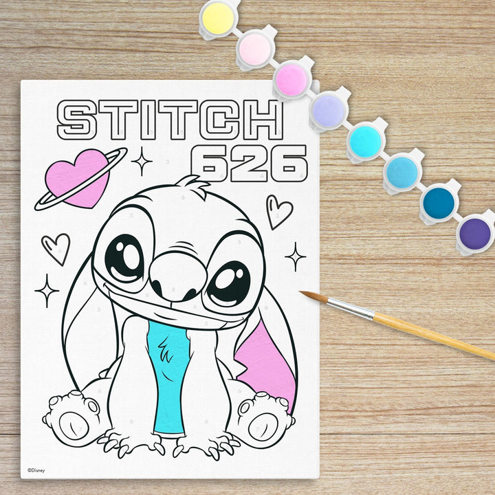 Coloring sheet with a cartoon character on a wooden surface with coloring supplies.