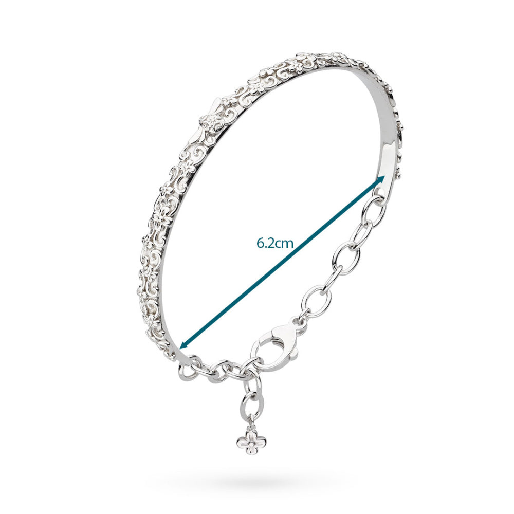 Silver bracelet with a chain and heart charm on a white background