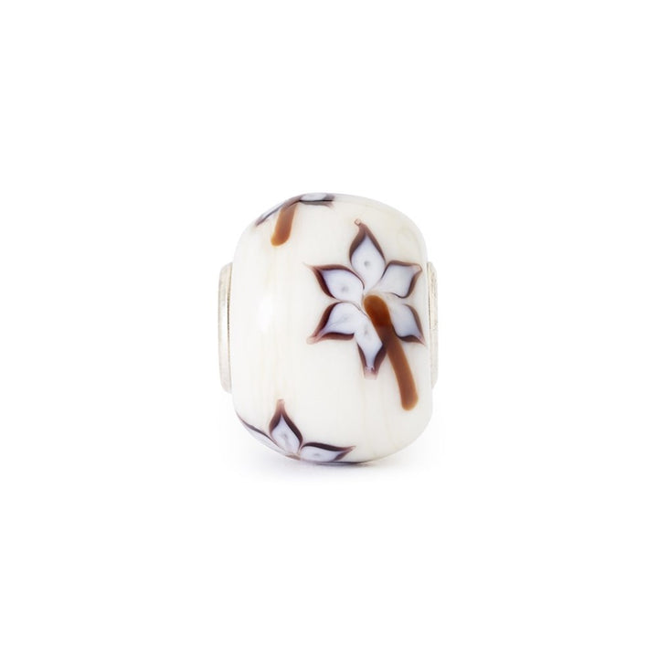 Decorative bead with floral design on a white background