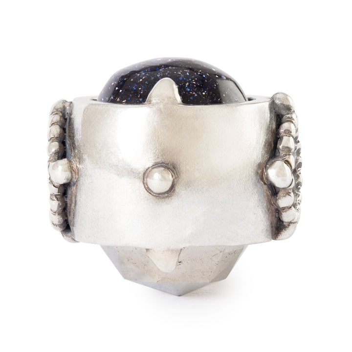 Silver ring with a dark blue gemstone on a white background