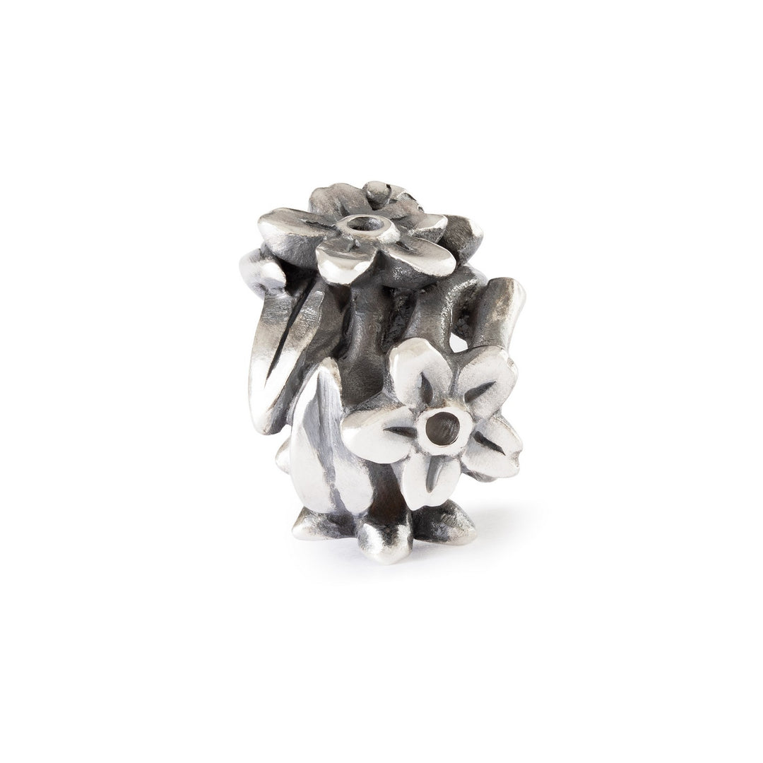 Silver floral charm on a white background