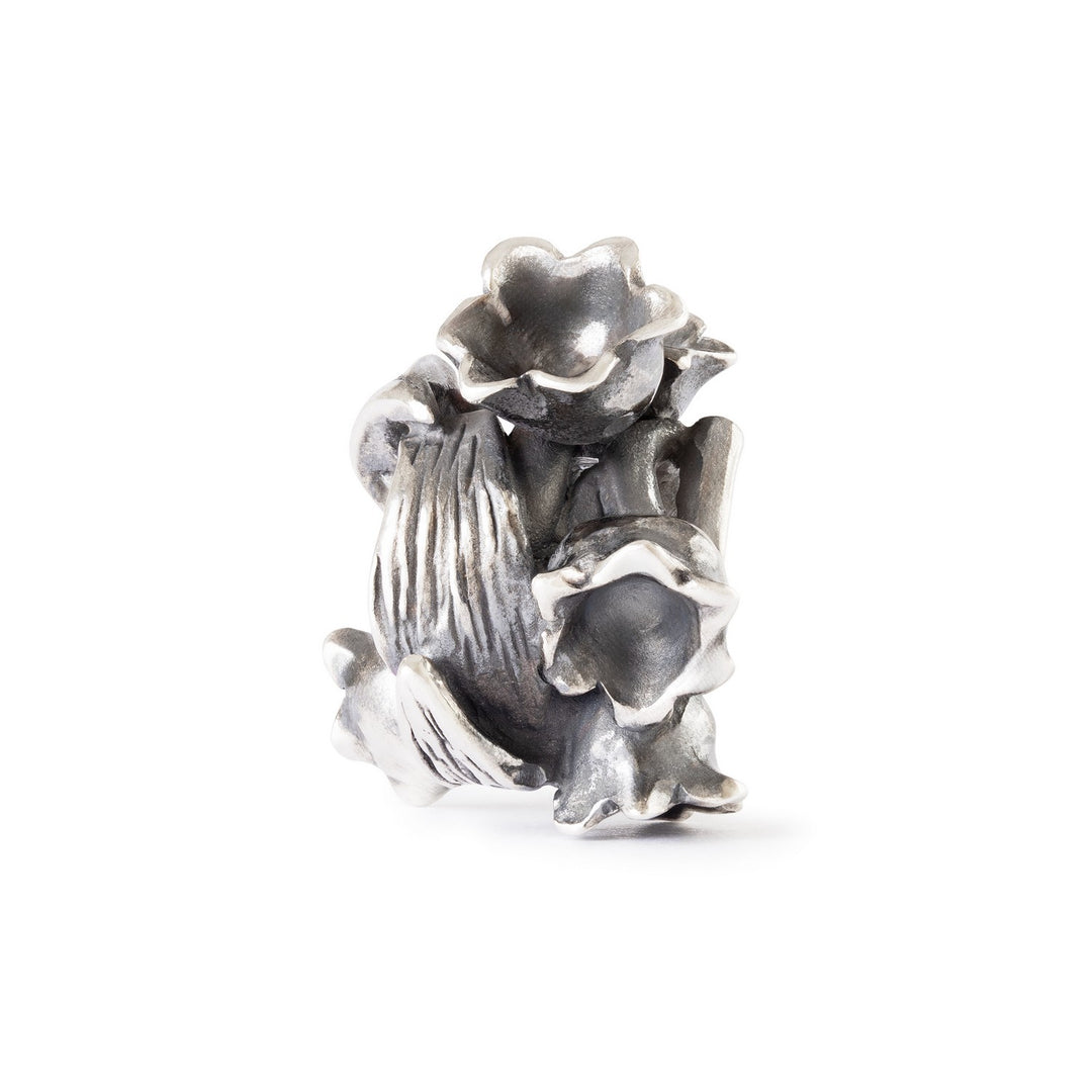 Silver floral charm on a white background