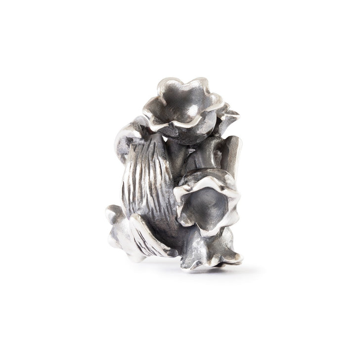 Silver floral charm on a white background