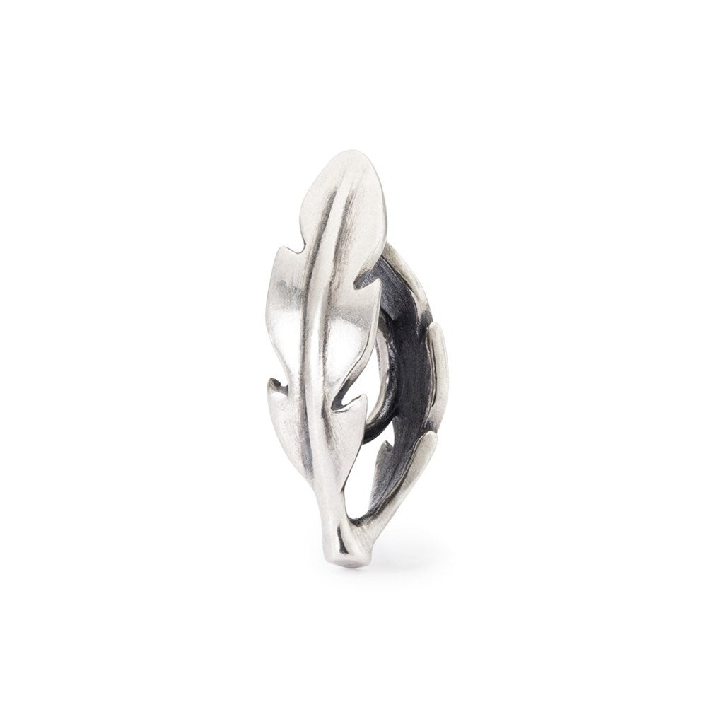 Silver feather-shaped charm on a white background