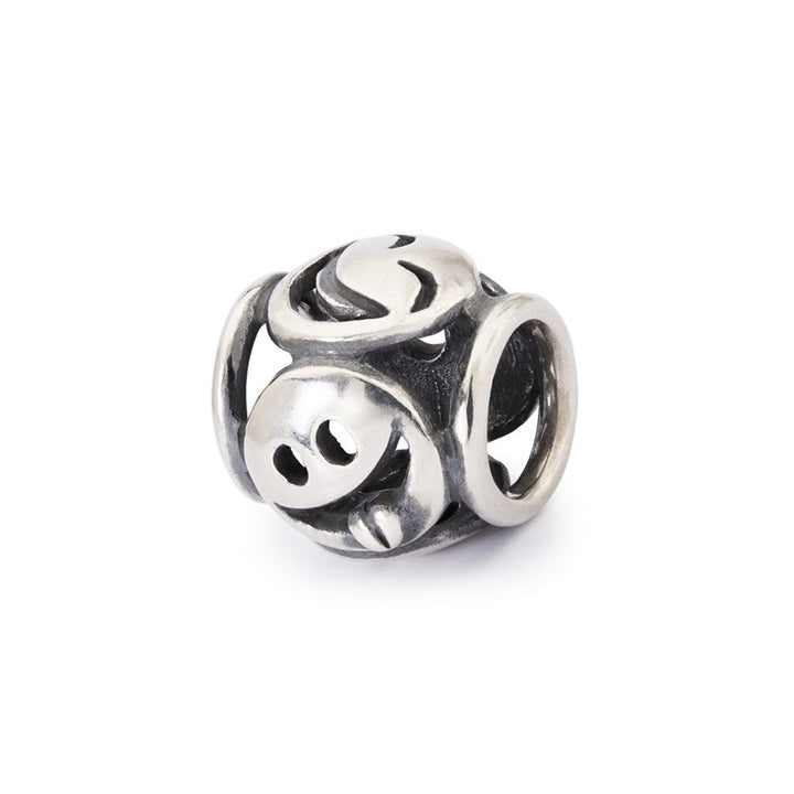 Silver bead charm with intricate design on a white background