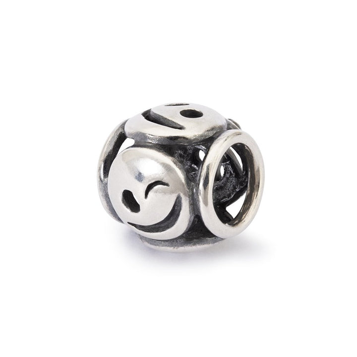 Silver bead charm with smiley face design on a white background