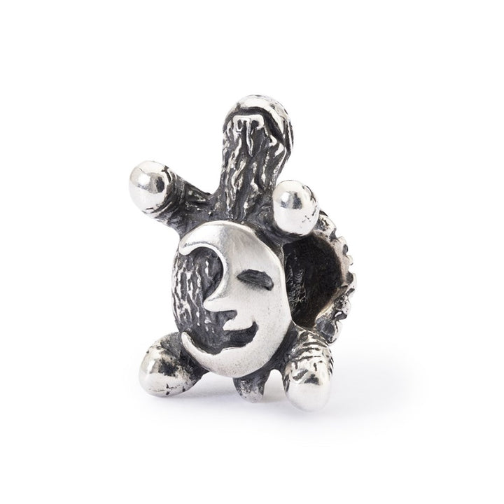 Silver charm with sun and moon design on a white background