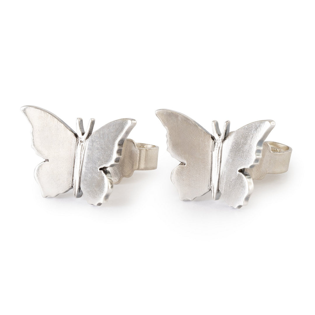 Silver butterfly earrings on a white background