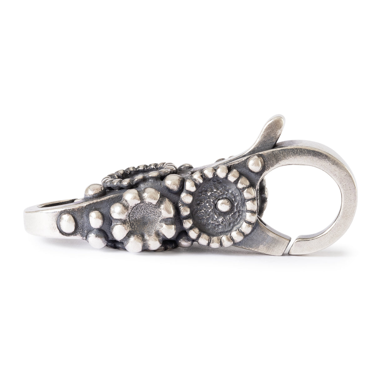 Silver keychain with floral design on a white background