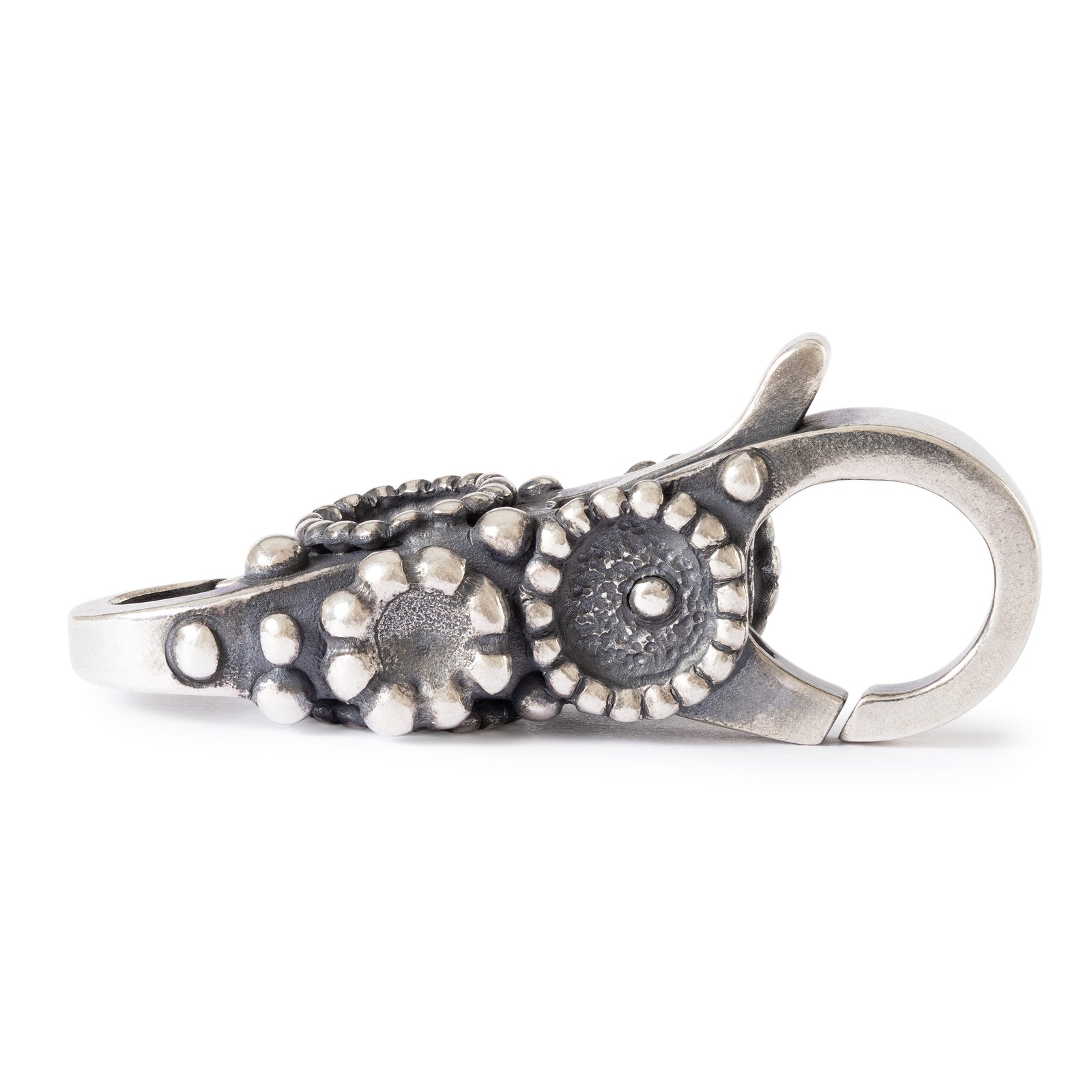 Silver keychain with floral design on a white background