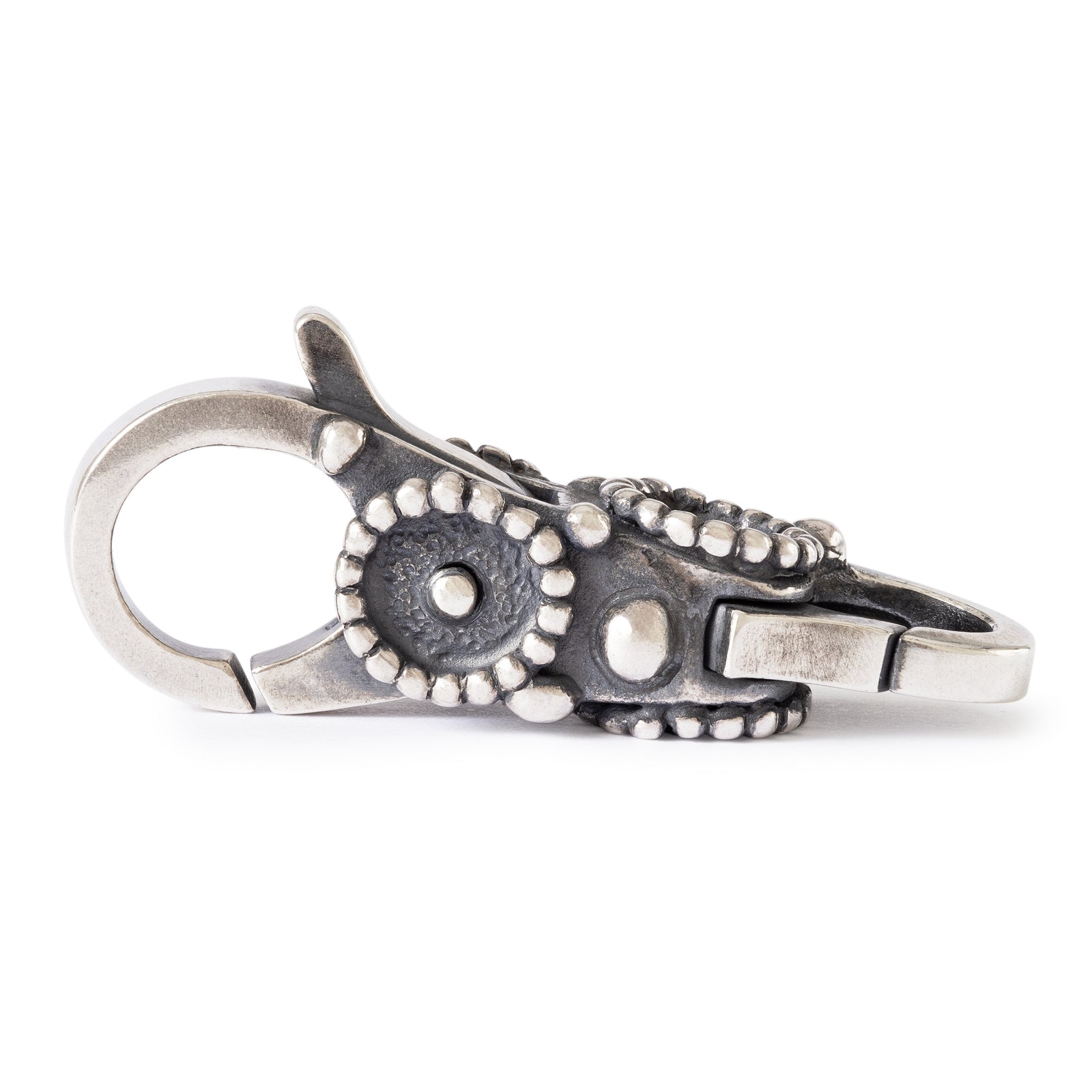 Silver keychain with floral design on a white background