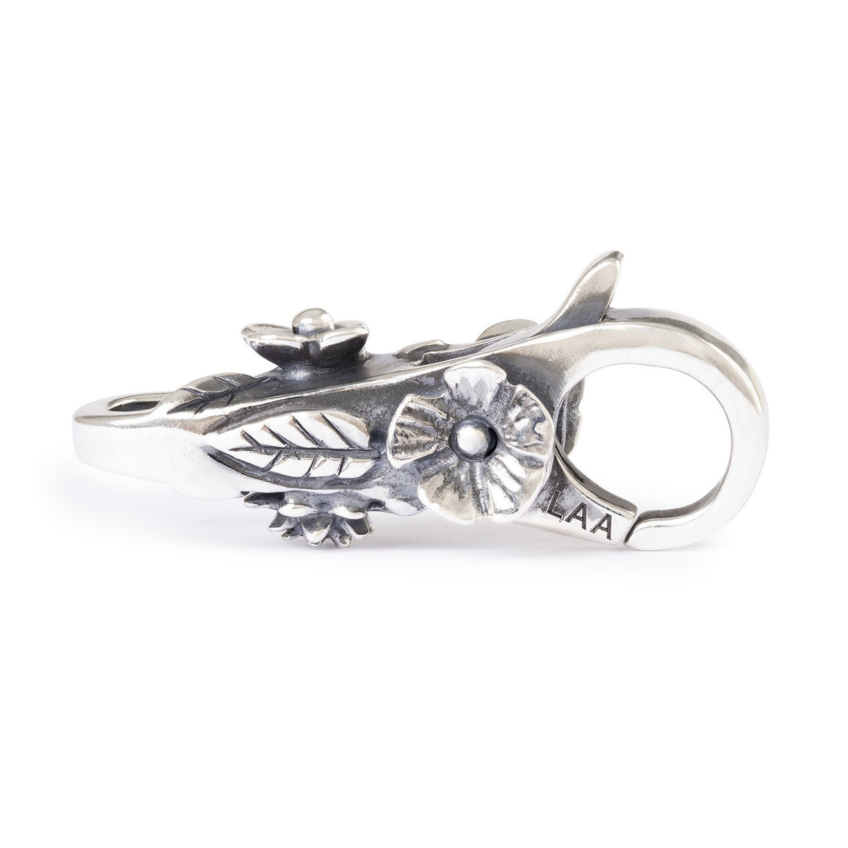 Silver clasp with intricate design on a white background