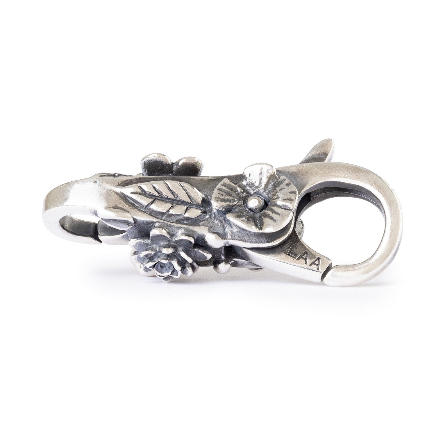 Silver clasp with intricate design on a white background