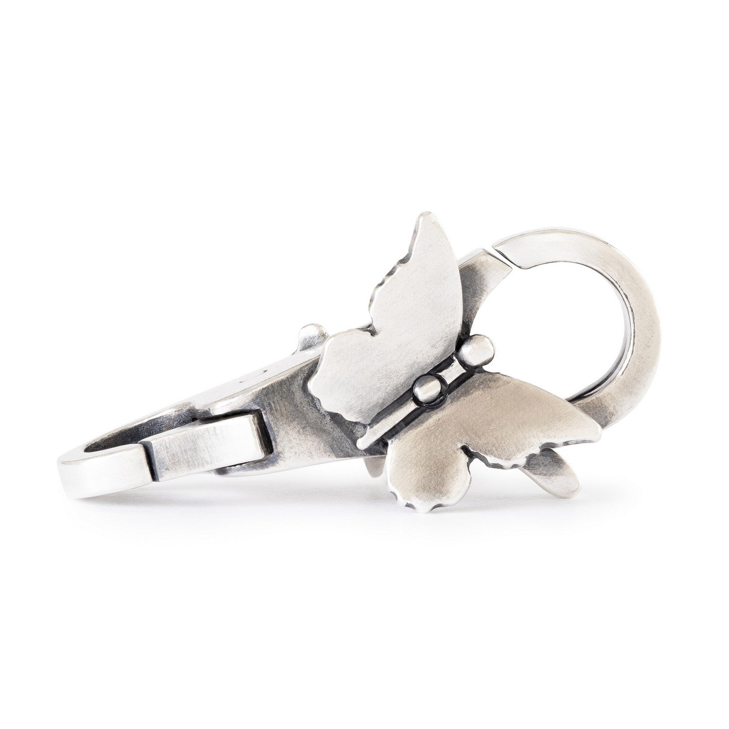 Silver dog-shaped keychain on a white background