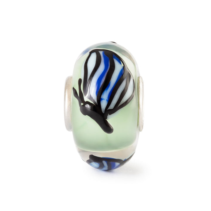 Glass charm with zebra pattern on a white background