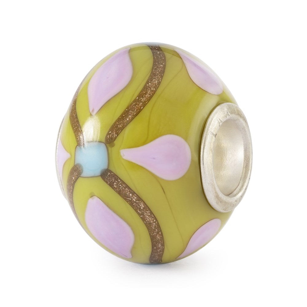 Decorative bead with floral patterns on a white background